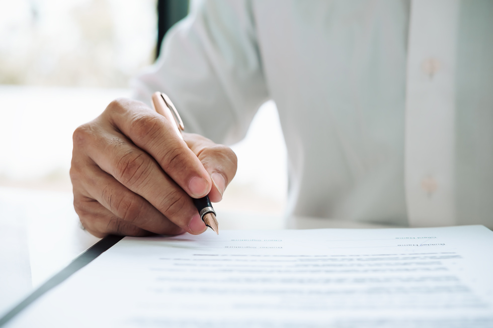 Man Signing a Contract Agreement